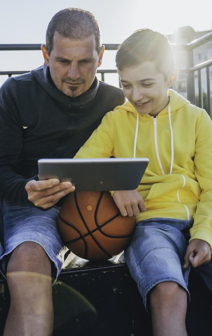 Parent and child playing basketball together